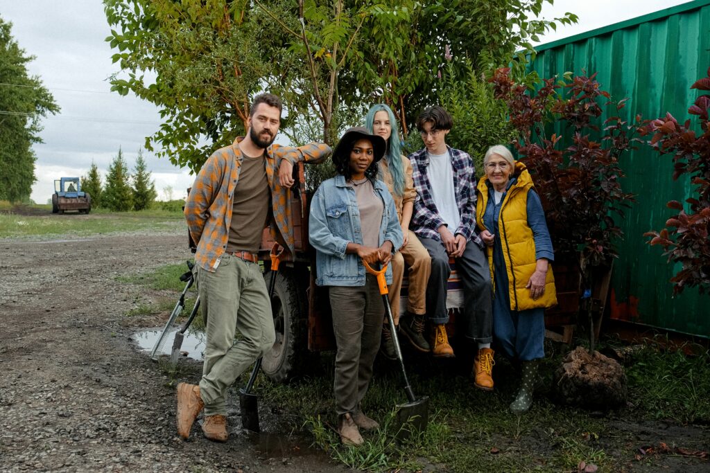 gas-pipeline A diverse group of farmers posing with tools and equipment outdoors, showcasing teamwork and agricultural lifestyle.